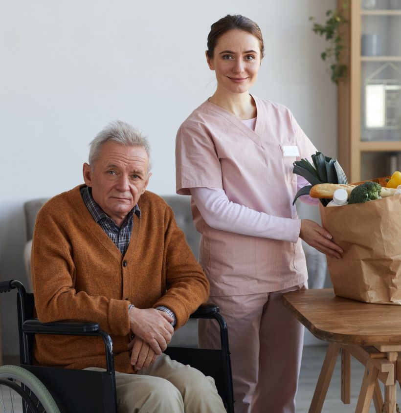 portrait-of-disabled-senior-man-with-female-caregiver.jpg